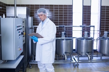 Man in lab coat in factory